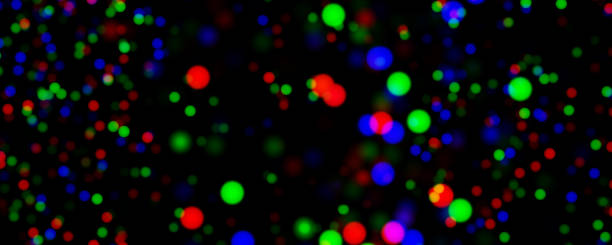 istock Background of abstract defocus multicoloured lights, red, green and blue against black backdrop, wide banner. 2162789992