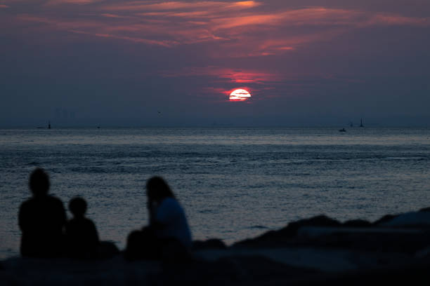 silhouettes of a walking couple in front of the Adriatic Sea at sunset
