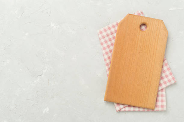 istock Cutting board with napkin on concrete background, top view 2162793658