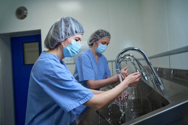 istock Two female doctors washing thoroughly hands before performing a surgery in clinic 2162795268