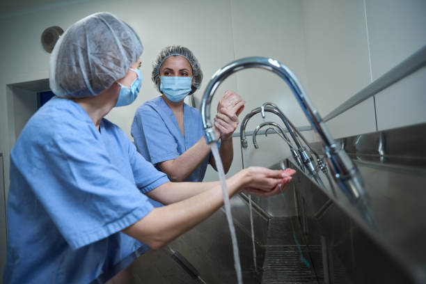 istock Surgeons in hospital washing thoroughly hands before performing a surgery 2162795271