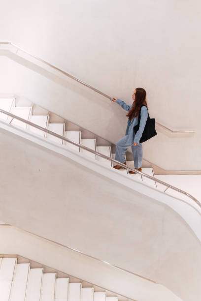istock Unrecognizable woman walking on stairs 2162797185