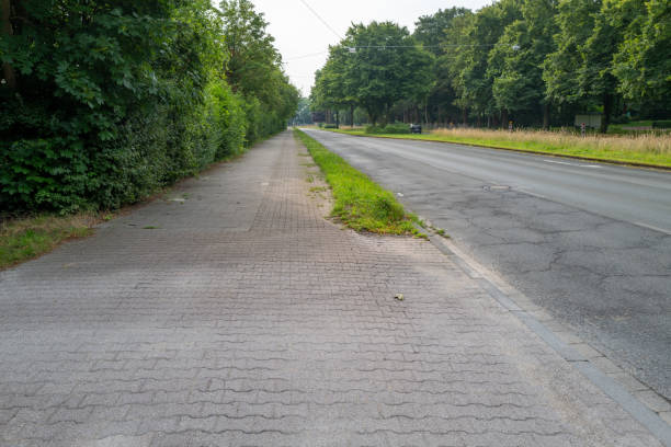 istock Empty asphalt road with pavement and grass verge 2162803006