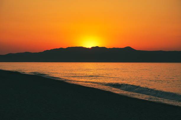 Sunset at Minoa's Beach, Crete, Greece behind a mountain