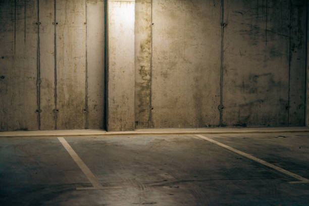 istock Empty underground garage. Parking lot with overhead dim light 2162810681