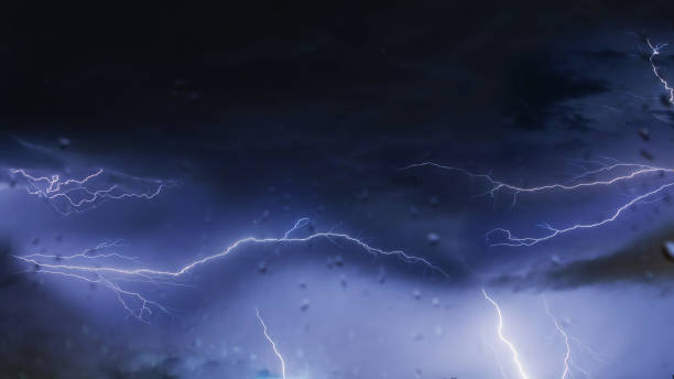 istock Lightning flashes in the night sky during a storm 2162810820