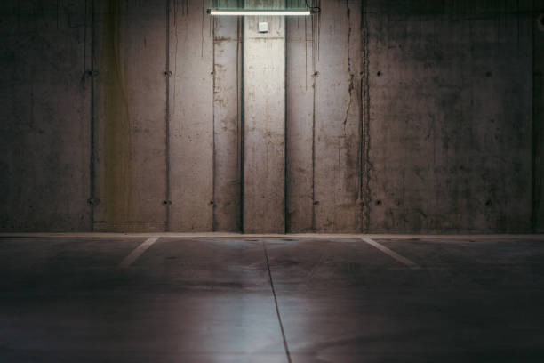 istock Empty underground garage. Parking lot with overhead dim light 2162810838