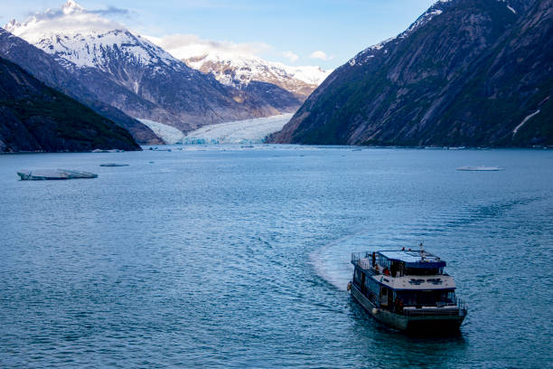 Skagway, Alaska - July 30, 2023: A cruise ship - Regent Seven Seas Explorer is sailing into the pier for docking. Skagway Harbor and Cruise Pier view, Alaska, USA.