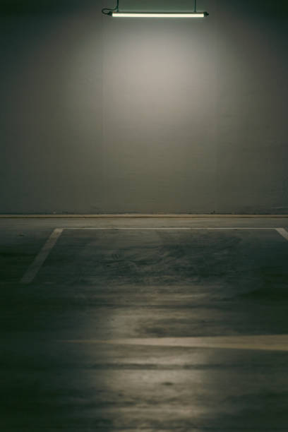 istock Empty underground garage. Parking lot with overhead dim light 2162811313