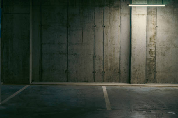 istock Empty underground garage. Parking lot with overhead dim light 2162812560