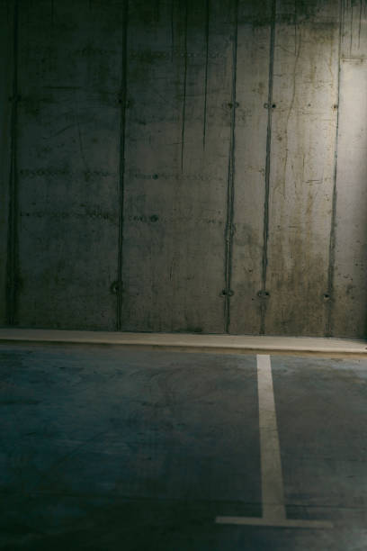 istock Empty underground garage. Parking lot with overhead dim light 2162812706