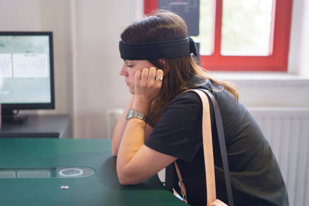 istock A young woman sits at a table with a sensor headband that measures brain activity. Applied science concept in real life 2162815378