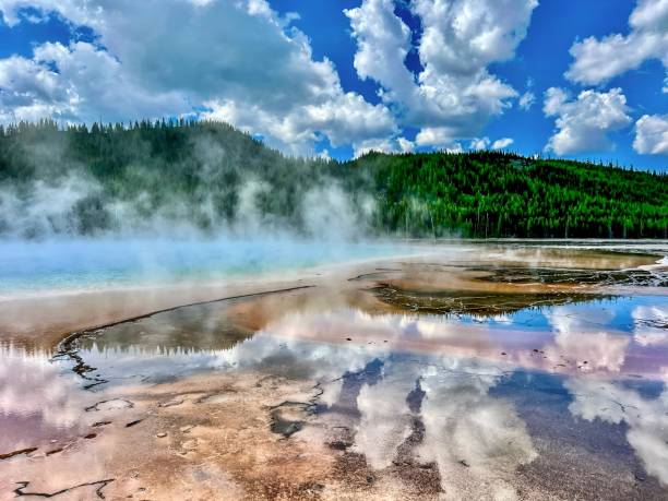 Puffy Clouds Reflect In Cascade Lake In Yellowstone National Park