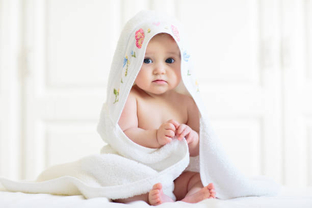 istock Little baby on white bed 2162817625