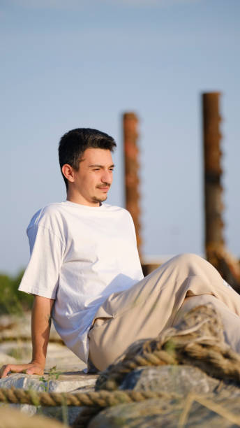 istock A handsome, young, dark-haired man spending time by the seaside 2162817640