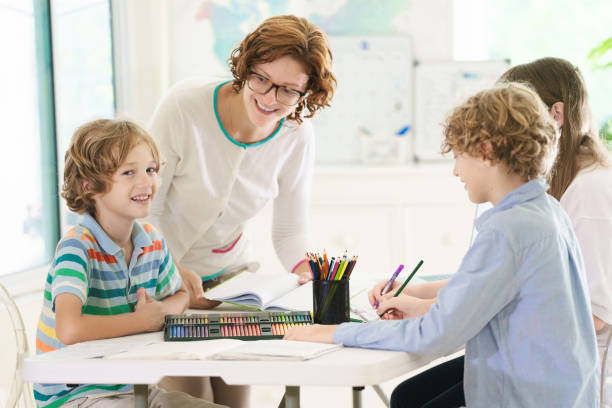 istock Back to school. Kids and teacher in classroom 2162817737