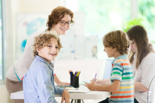 istock Back to school. Kids and teacher in classroom 2162818205