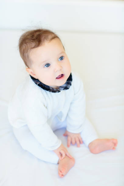istock Little baby on white bed 2162818579