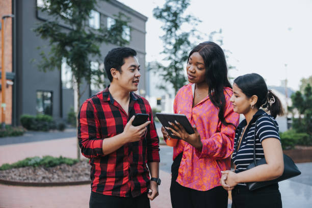 istock Three colleagues having a quick outdoors meeting in front of their office 2162820945
