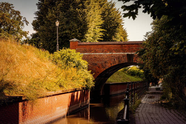 Beautiful old brick arched bridge and a canal. Autumn countryside