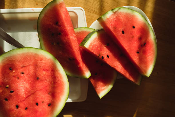 Above shot of freshly cut slices of watermelon placed on a table in the kitchen