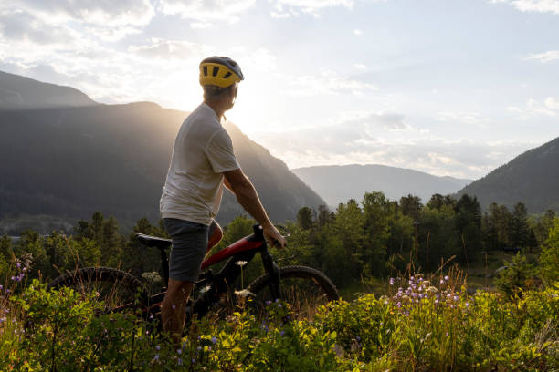 istock Mature man mountain biker pauses in meadow 2162823590