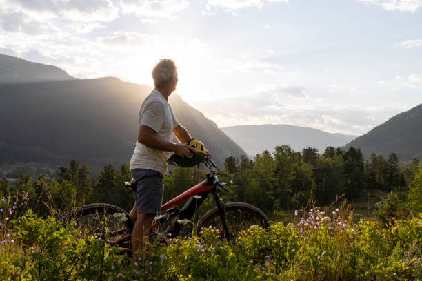 istock Mature man mountain biker pauses in meadow 2162823591
