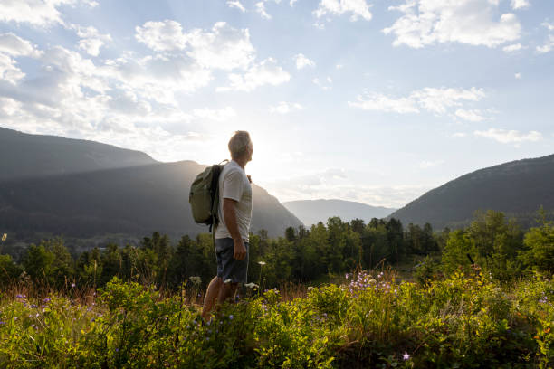 istock Senior man explores meadow in autumn 2162823598