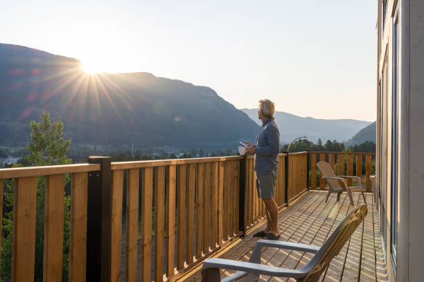 istock Senior man looks at mountains from verandah 2162823605