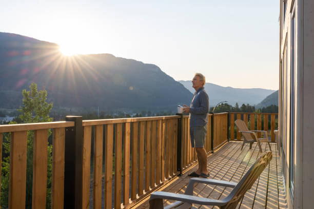 istock Senior man looks at mountains from verandah 2162823608
