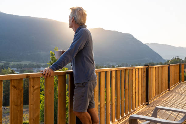 istock Senior man looks at mountains from verandah 2162823611