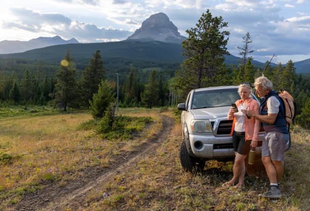 istock Mature couple relax beside vehicle 2162823656