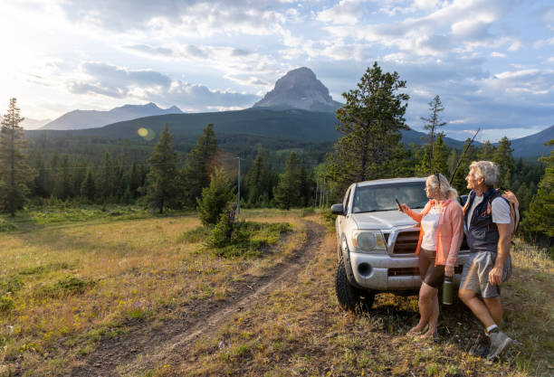 istock Mature couple relax beside vehicle 2162823659