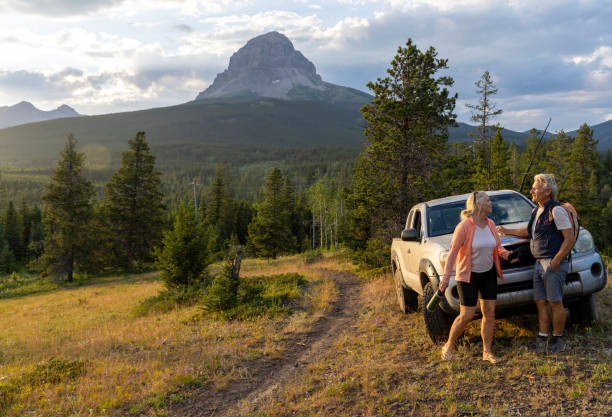istock Mature couple relax beside car 2162823733