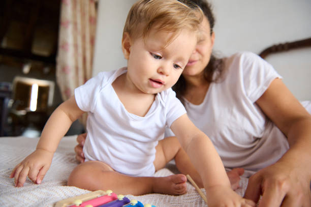 istock Mother and young child playing together in a cozy home setting 2162826812