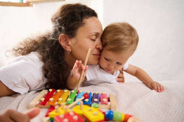 istock Mother and baby bonding while playing with colorful xylophone 2162828242