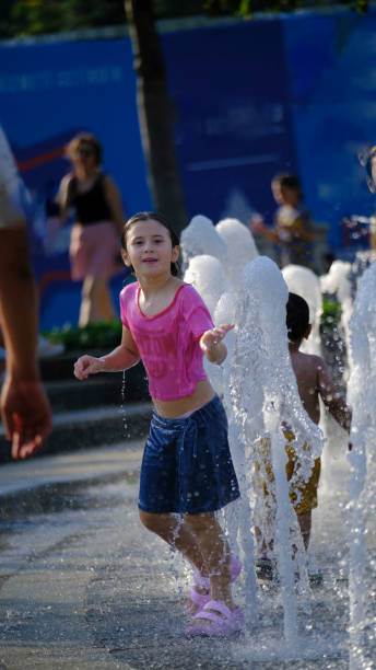 istock Girl is having fun playing with the water on a summer day 2162829749