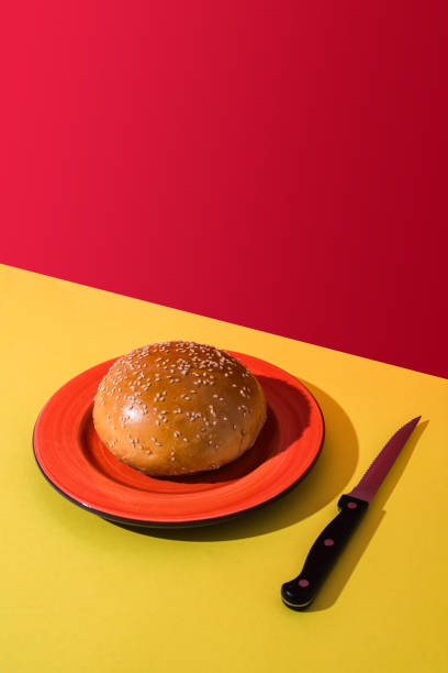 istock A hamburger bun and a knife. Copy space. 2162830195