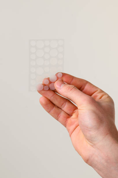 istock Acne pimple patch effective bandage to clean your face from open and closed pimples. Acne pimple patch that helps to get rid of zits on problematic parts of skin. 2162831435