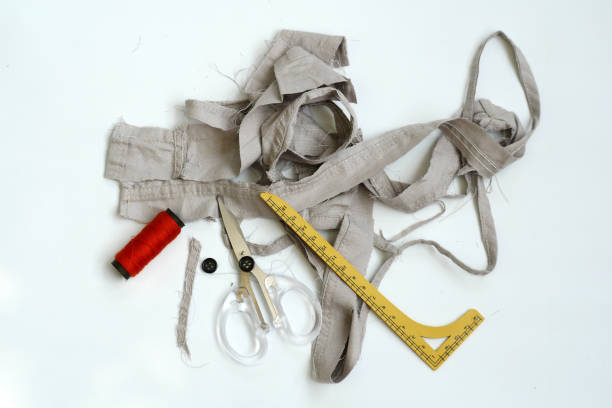 istock Sewing equipment and leftover fabric pieces isolated on white background 2162832836