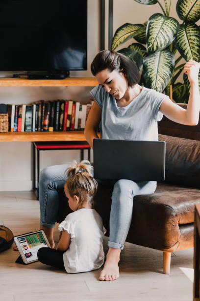 istock Mother celebrating success while working from home with daughter 2162835441