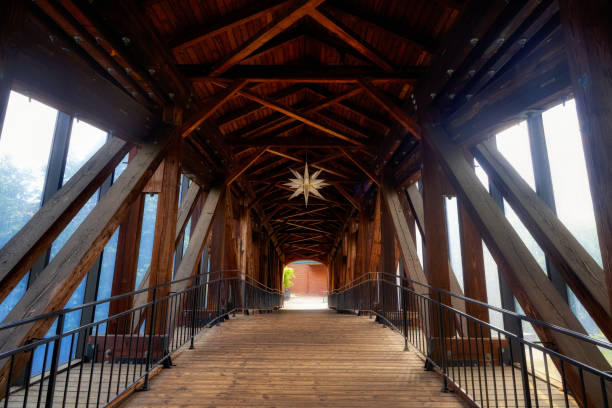 An interior view inside the Heritage Covered Bridge with timber beams and a hanging Moravian Star in Winston Salem in North Carolina.