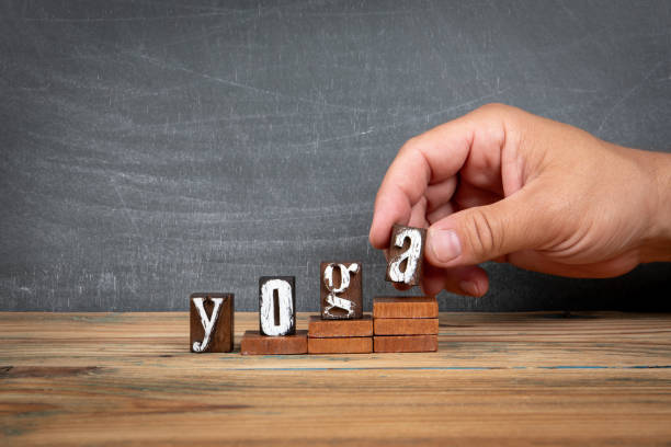 istock YOGA. Wooden letters, alphabet blocks on steps. development and growth concept 2162837464
