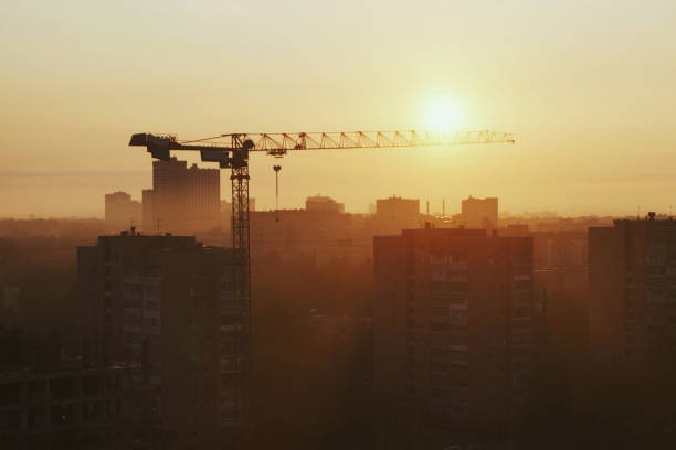 istock Construction crane above buildings arrow pointing towards the sun 2162839448