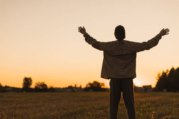 istock Male silhouette against sunset background. 2162840816