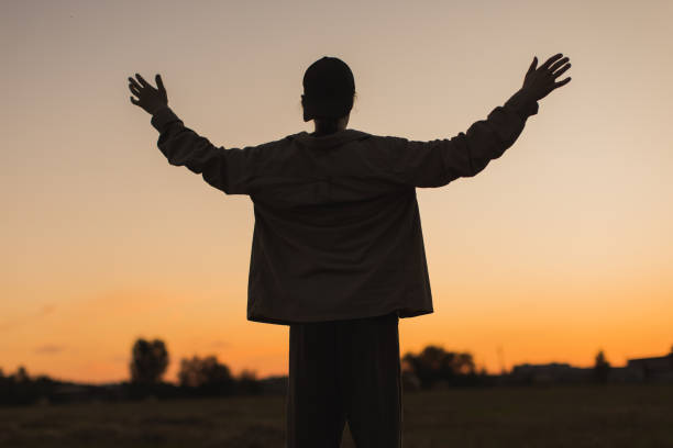 istock Male silhouette against sunset background. 2162840876