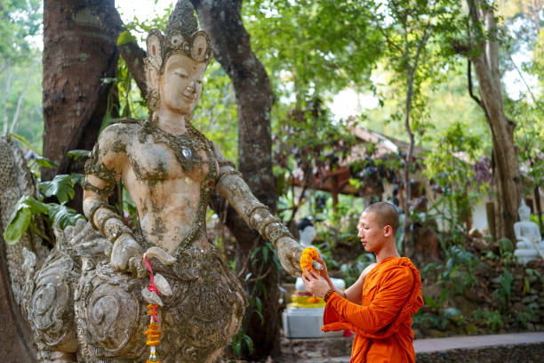 Thai Buddhism monk making offering at the temple