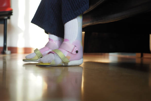 Rough male feet with untreated cuticles and hairy toes stand on wooden floor