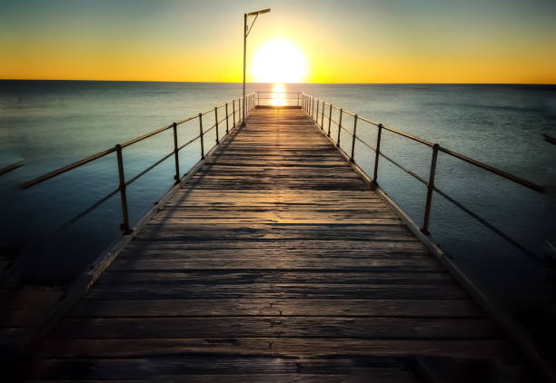 istock Sun setting at the end of a jetty 2162857781