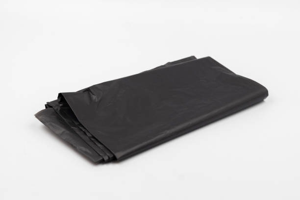 istock Black plastic garbage bags on white background, Roll of garbage bags on white background 2162858052